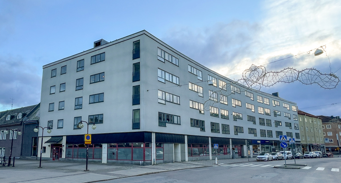 Vy över fastigheten med sin bågformade fasad sett från Drottninggatan