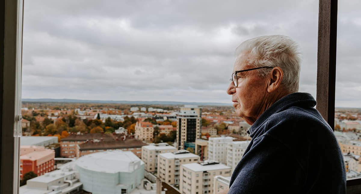 Lars-Åke Larsson står på sin balkong högst upp i Krämarhuset och tittar ut över Örebro.